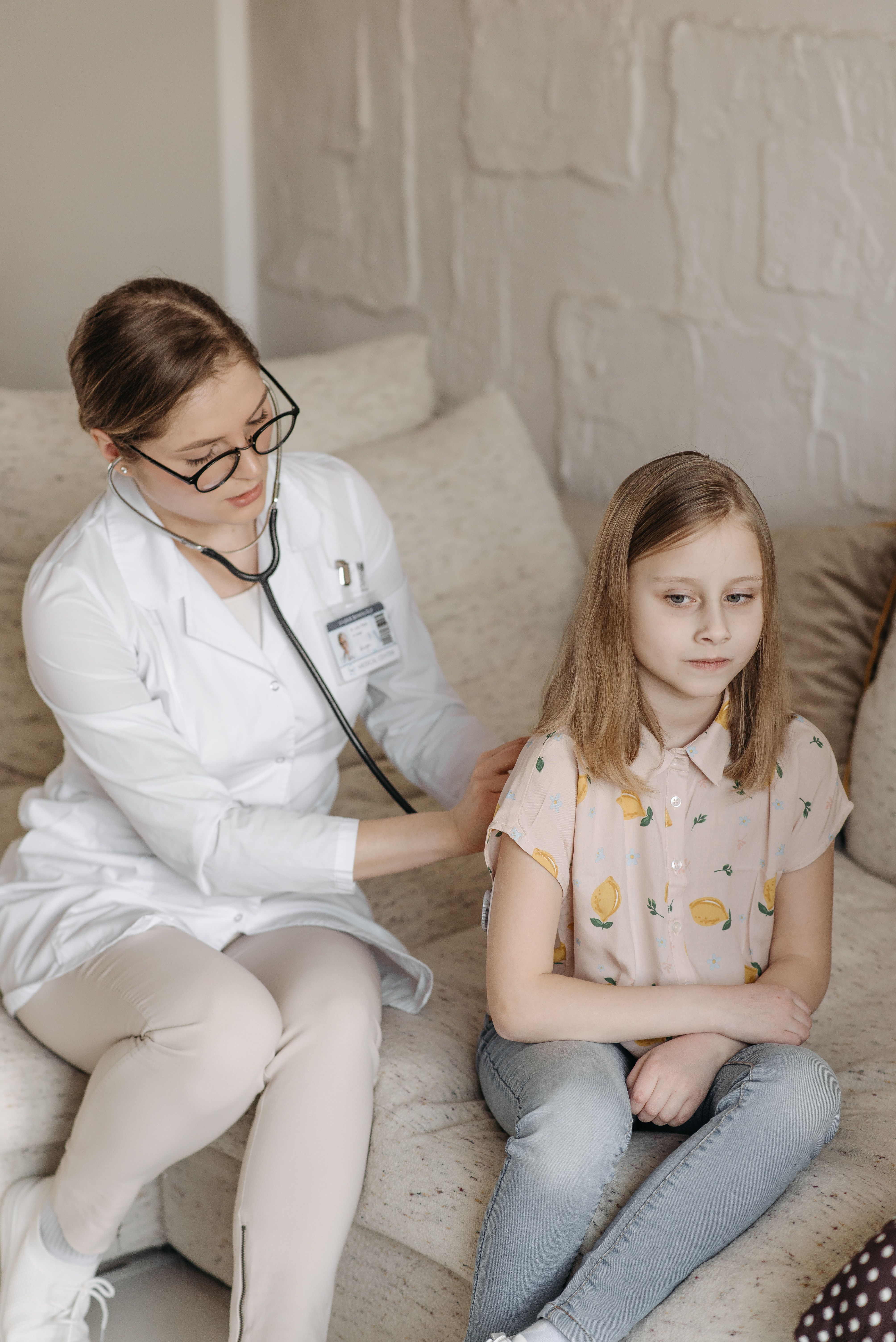 Healthcare professional checking a child
